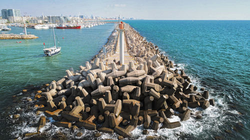 Stack of rocks in sea against sky