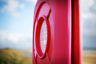 Close-up of telephone booth against sky