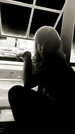 Close-up of woman standing against wall