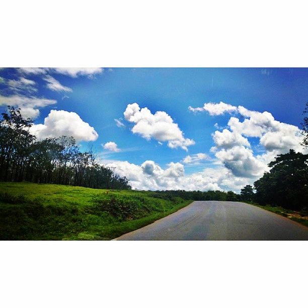 sky, transfer print, transportation, road, tree, the way forward, landscape, cloud, cloud - sky, auto post production filter, country road, diminishing perspective, tranquil scene, tranquility, nature, road marking, field, beauty in nature, scenics, vanishing point