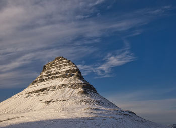 Low angle view of snowcapped mountain against sky