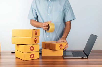 Midsection of woman holding toy blocks on table