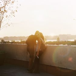 Couple standing against sky