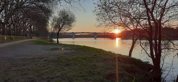 Scenic view of lake against sky during sunset