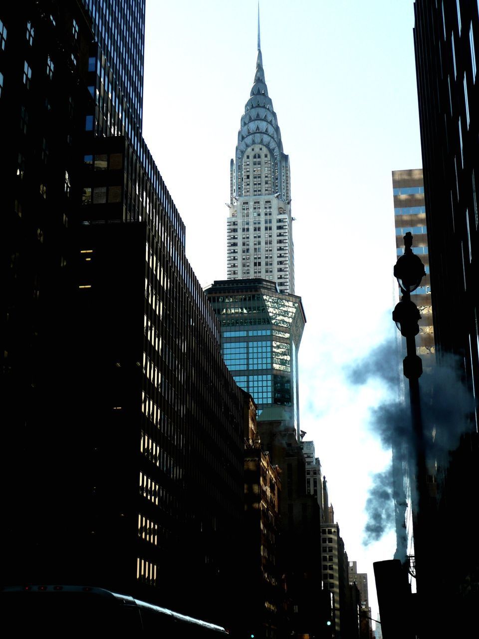 LOW ANGLE VIEW OF SKYSCRAPERS AGAINST CLOUDY SKY