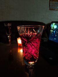 Close-up of red wine in glass on table