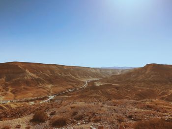 Scenic view of mountains against clear blue sky