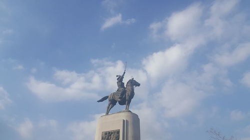 Low angle view of statue against sky