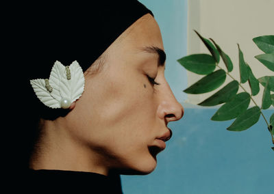 Close-up of young woman with flower