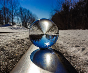 Close-up of crystal ball on glass