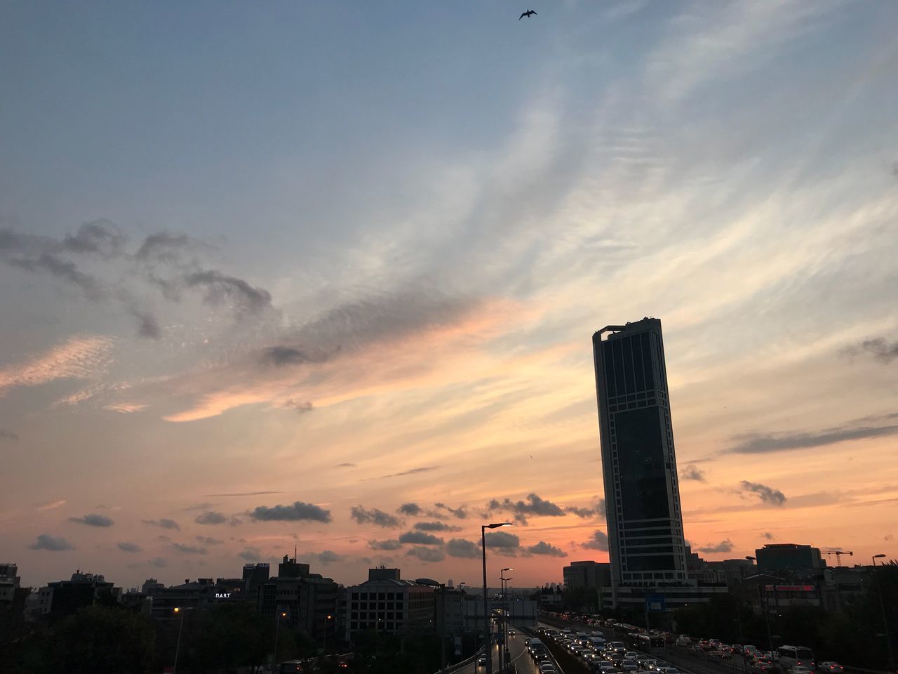 BUILDINGS AGAINST CLOUDY SKY DURING SUNSET