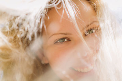 Close-up portrait of smiling young woman