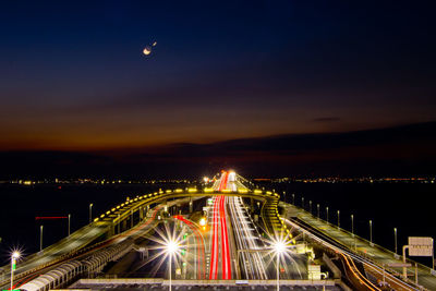 High angle view of illuminated bridge against sky at night