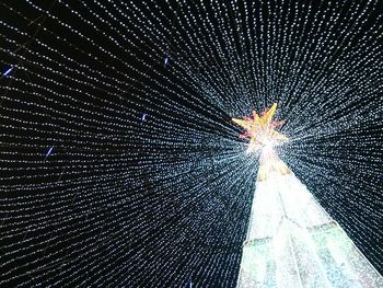 Low angle view of firework display at night