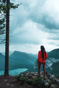 Rear view of woman standing on snow covered mountains