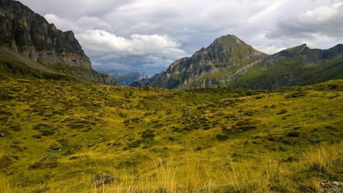 Scenic view of mountains against cloudy sky