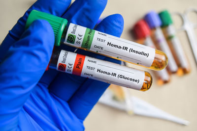 Midsection of woman holding thermometer