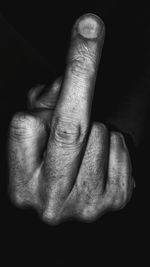 Close-up of human hand against black background