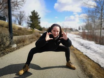 Full length of young woman on the road