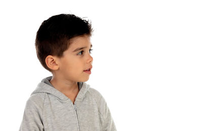 Portrait of boy looking away against white background