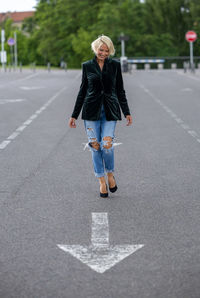 Full length of woman walking on road