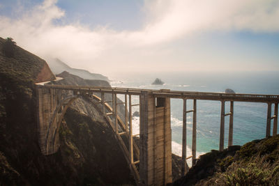 Bridge over sea against sky