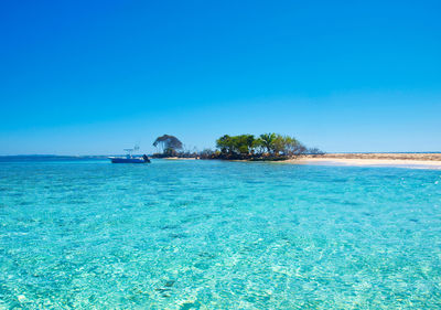 Scenic view of sea against clear blue sky