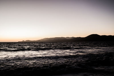 Scenic view of sea against clear sky during sunset