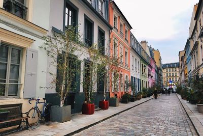 Street amidst buildings in city against sky