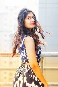 Portrait of beautiful young woman standing outdoors