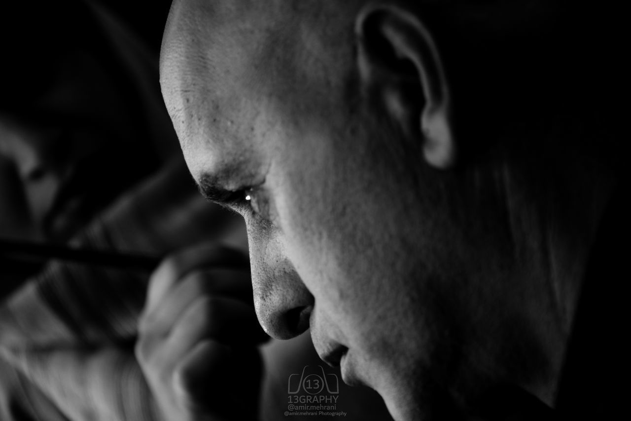 CLOSE-UP OF YOUNG MAN LOOKING AWAY