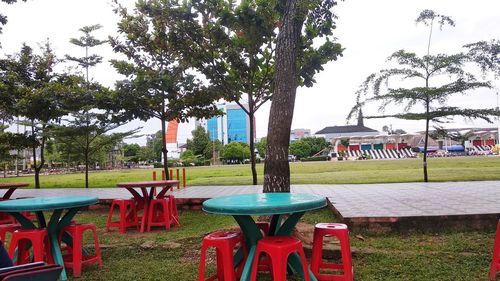 Empty chairs and table in park