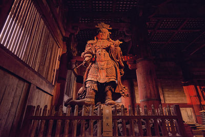 Low angle view of statue against historic building