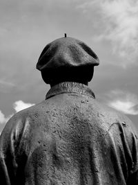 Rear view of man standing against sky