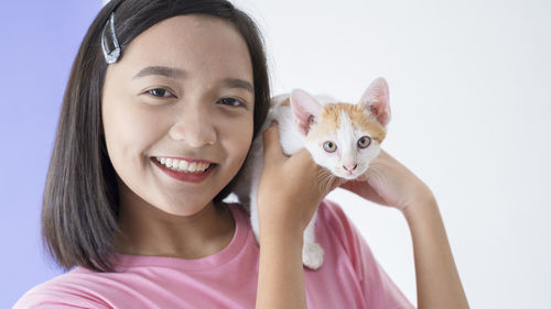 Portrait of smiling woman with cat