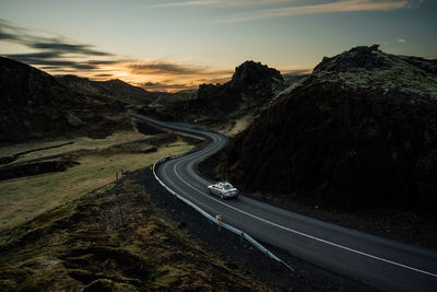 Car driving on road in evening in countryside