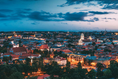 High angle view of illuminated cityscape against sky at dusk