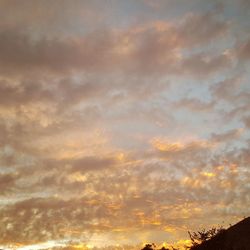 Low angle view of cloudy sky at sunset