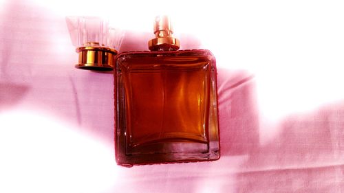 Close-up of wineglass on table against white background