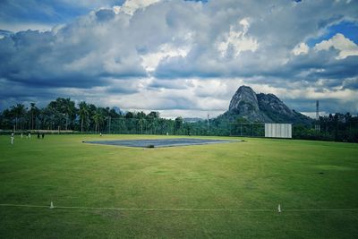 Built structure on field against sky