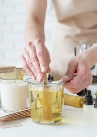 Midsection of woman holding drink