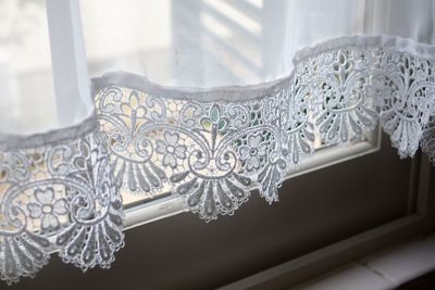 Close-up of curtain on window at home