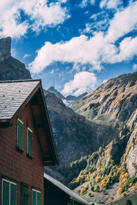 Low angle view of building and mountains against sky