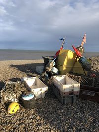 Low angle view of abandoned ship on beach against sky