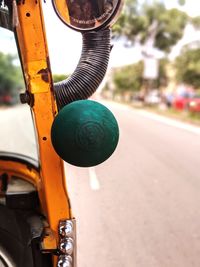 Close-up of yellow motorcycle on road