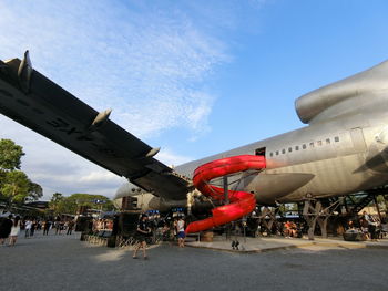 Airplane on runway against sky