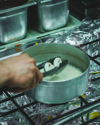 Cropped image of person preparing food in kitchen