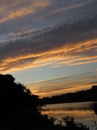 Scenic view of lake against orange sky