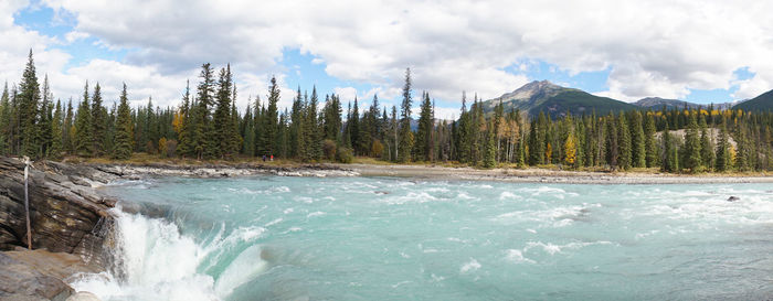 Scenic view of waterfall against sky