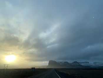 Road amidst landscape against sky during sunset